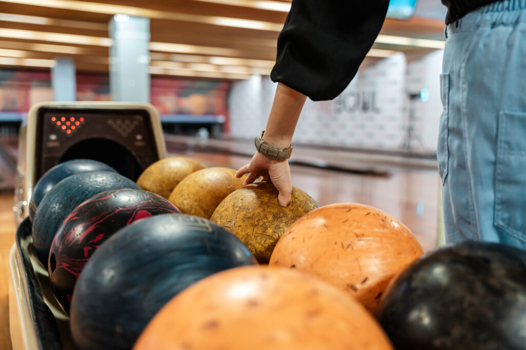 Man picking bowling ball
