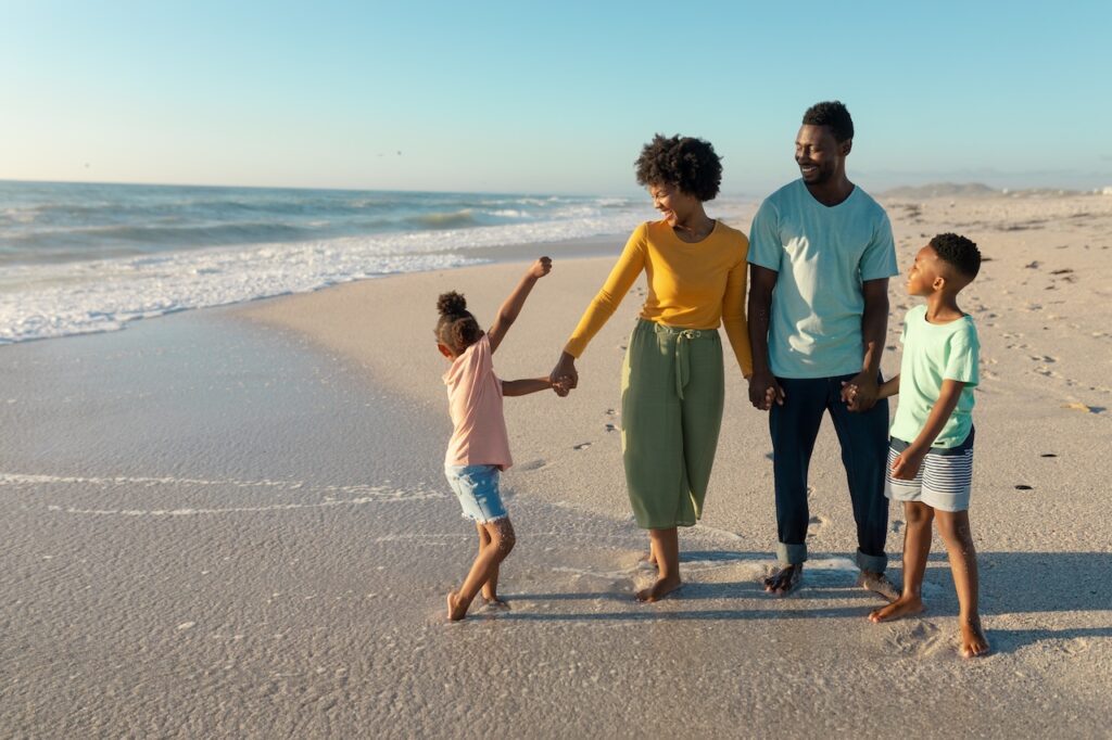 happy family with two kids on the beach in south carolina